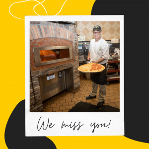 Photo of Campus Dining team member pulling a pizza out of the oven with caption