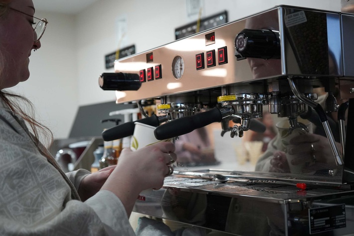 Staff preparing a drink at coffee machine